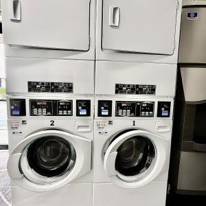 three washing machines are stacked next to each other at Red Roof Inn & Suites Newport - Middletown, RI in Middletown