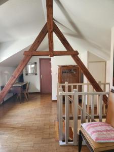 a room with a roof with wooden beams at L'Escapade de Zillis in Zillisheim +7 photos