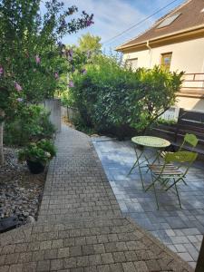a patio with a table and chairs and flowers at L'Escapade de Zillis in Zillisheim