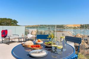 a blue table with food on top of a patio at Panoramic harbour views Morva in Falmouth
