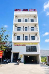 a white hotel with a sign on top of it at Minh Anh Hotel Nghệ An in Vinh +13 photos