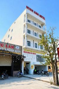 a building with motorcycles parked in front of it at Minh Anh Hotel Nghệ An in Vinh
