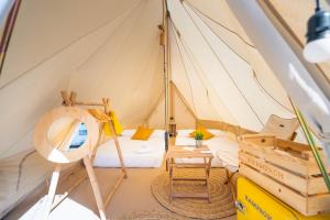 a bedroom in a sailboat with a bed and a table at Kampaoh Blanes in Blanes
