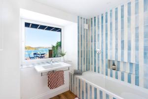 a bathroom with a sink and a window at Panoramic harbour views Morva in Falmouth +22 photos