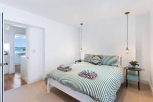a bed with two pillows on it in a bedroom at Panoramic harbour views Morva in Falmouth