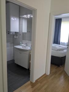 a bathroom with a sink and a bed and a mirror at Nassfeldpass Pistenblick in Sonnenalpe Nassfeld +38 photos
