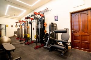 a gym with a bunch of equipment in a room at Fit Haus - A Boutique Hotel in Kolkata