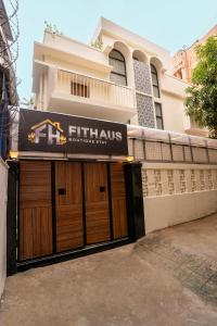 a building with a pair of wooden garage doors at Fit Haus - A Boutique Hotel in Kolkata