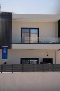 a building with a balcony on the side of it at LUMINA Luxury Suites in Missolonghi