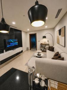 a living room with a couch and a tv at The Vista 1BR by Winchester in Mall of Islamabad F-7 Margalla & City Views in Islamabad