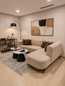 a living room with a couch and a table at The Vista 1BR by Winchester in Mall of Islamabad F-7 Margalla & City Views in Islamabad
