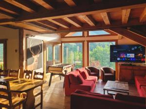 a living room with red furniture and a large window at Charming Chalet w/ Mountain & Slope Views, Jacuzzi in Vars