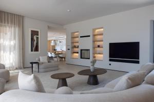 a living room with a couch and a tv at Villa Kairos in Foiníki