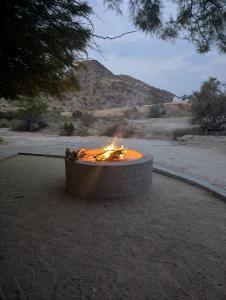 a fire pit in the middle of the desert at Achab Camping Camp site in Usakos +25 photos