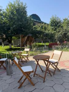 a group of picnic tables and chairs on a patio at Дом 14 in Osh