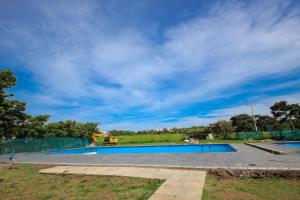 an empty swimming pool with a blue sky at 3 bedrooms Entebbe Lake-House with Pool,Private Beach, Kids Park and AC in Kagolomolo