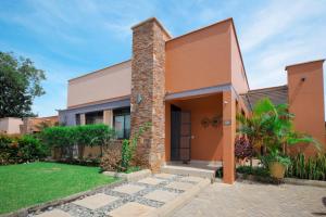 a house with a brick pillar at 3 bedrooms Entebbe Lake-House with Pool,Private Beach, Kids Park and AC in Kagolomolo