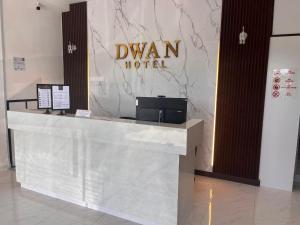 a lobby of a hotel with a sign on the wall at Dwan Hotel in Kota Bharu