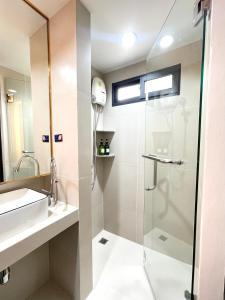 a bathroom with a shower and a sink at RESET at DMK Hotel in Don Muang Airport +32 photos