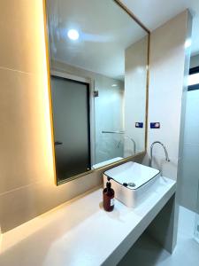 a bathroom with a sink and a mirror at RESET at DMK Hotel in Don Muang Airport