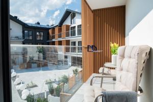 a balcony with a view of a building at Laguna Beskidów Resort - Studio Sultanit in Zarzecze