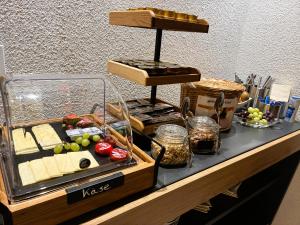 a buffet with cheese and other foods on a table at Hotel Garni KAMBEITZ in Ötigheim