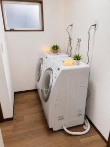 a washing machine in a laundry room with a window at Heart Warmer in Myoko