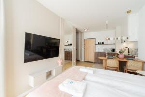 a bedroom with a bed and a living room at Laguna Beskidów Resort - Studio Sultanit in Zarzecze
