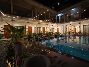 a pool in a building with a lot of plants at Lumora Fresh Wave Arugambay in Arugam Bay