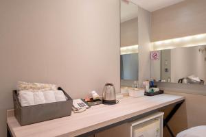 a bathroom with a counter with towels and a mirror at Busan Gwangalli SEAYOU HOTEL in Busan