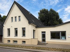 a white house with a black roof at Blue Stay Bremen in Bremen