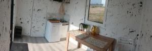 a kitchen with a small refrigerator and a table at ИНХаус Долинка in Cholpon-Ata +1 photo