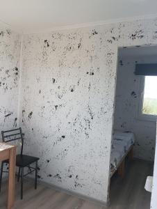 a room with a wall covered in black and white paint at ИНХаус Долинка in Cholpon-Ata
