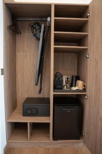 a cabinet with a microwave and a baseball bat at LUMINA Luxury Suites in Missolonghi