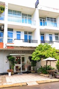 a rock hotel with an umbrella in front of it at Lucky Hotel in Phước Lai