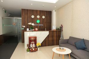 a living room with a couch and a fireplace at Lucky Hotel in Phước Lai