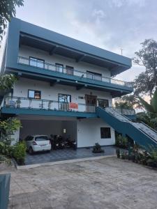 a building with a car parked in front of it at Vrindavan Villa Homestay in Cherambane