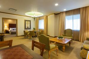 a living room with a table and a dining room at Crowne Plaza Torreon by IHG in Torreón