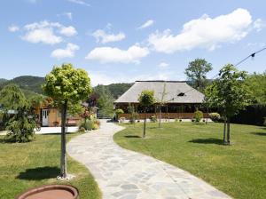 a walkway leading to a house in a park at Ograda Bunicului Seaca in Gura Văii