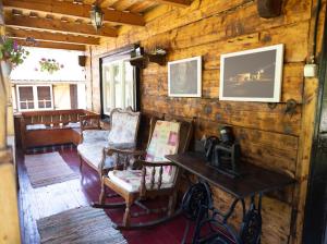 a living room of a log cabin with a table and chairs at Ograda Bunicului Seaca in Gura Văii