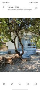 a picture of a tree in front of a house at La cabane provençale in Chamaret
