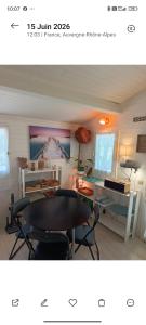 a room with a table and chairs in a room at La cabane provençale in Chamaret