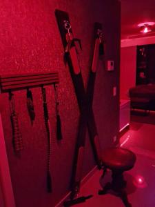 a room with a red room with a bench and umbrellas at Arlove Room in Arlon