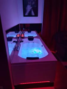 a bathroom with a bath tub with a sink at Arlove Room in Arlon
