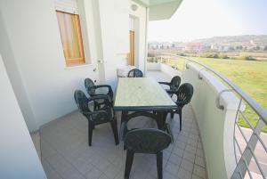 a patio with a table and chairs on a balcony at Residence Seaside in Tortoreto Lido