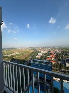 a view of the city from the balcony of a building at Halo Apartemen in Kebomas