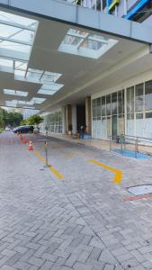 a large building with yellow lines in front of it at Halo Apartemen in Kebomas
