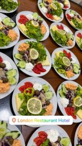 a bunch of plates of food on a table at London Restaurant Hotel in Kukës