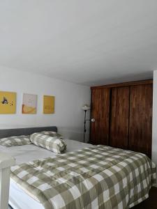 a bedroom with a bed with a plaid blanket at Halo Apartemen in Kebomas +7 photos