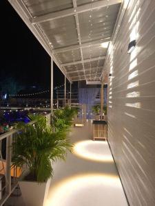 a balcony with plants and lights on a building at U House Homeytel in Ban Tai